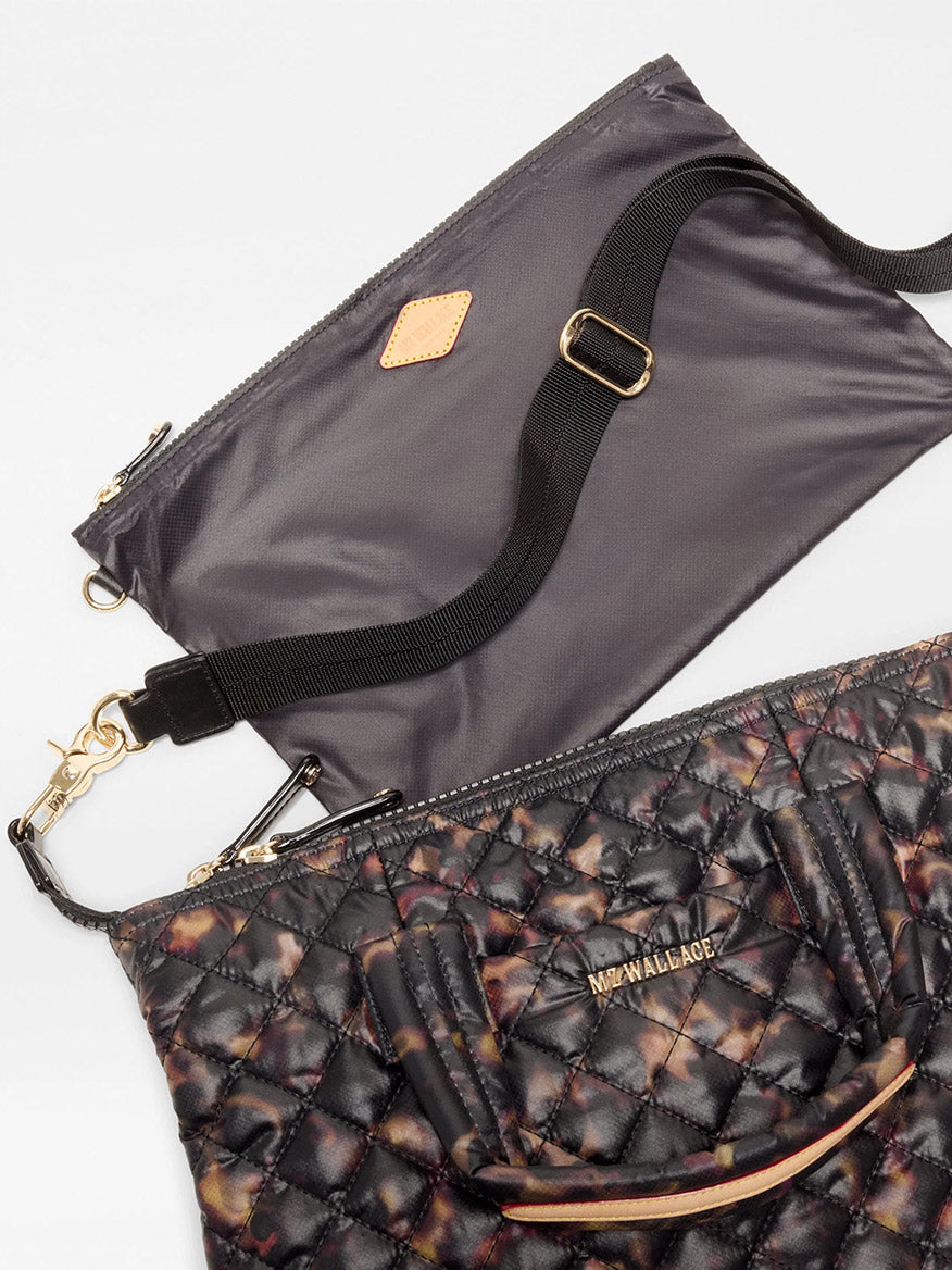 MZ Wallace Small Sutton Deluxe in Tortoise Shell Oxford, a quilted, tortoiseshell-patterned crossbody tote with dual handles, a detachable black strap, and an included zippered pouch.