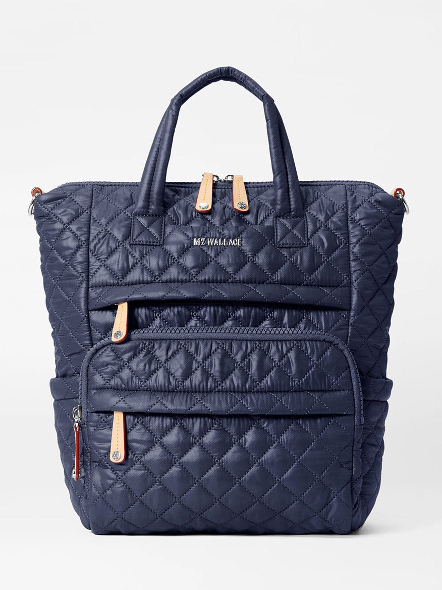 MZ Wallace Small Utility Backpack in Dawn Oxford in navy blue with quilted design, featuring two front zipper pockets, top handles, and adjustable shoulder straps. Made from recycled oxford, it fits a 14" laptop perfectly.