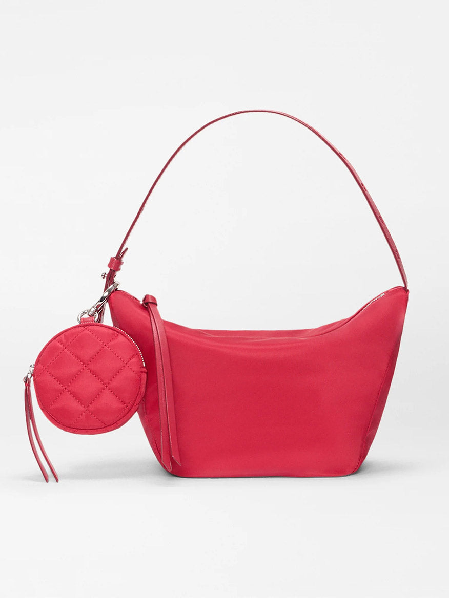 The MZ Wallace Small Waverly Hobo in Apple Bedford is a red Italian leather shoulder bag with a rounded rectangular shape, matching quilted coin purse, top handle, and secure zip closure.