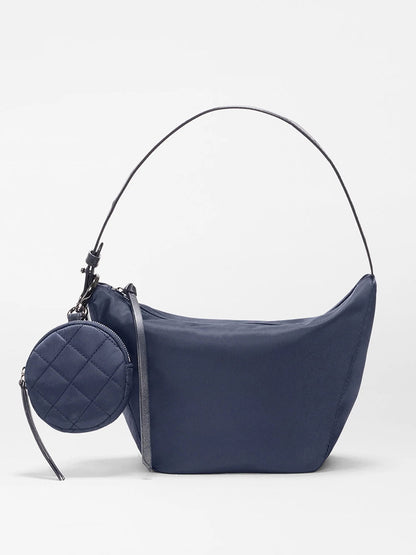 The MZ Wallace Small Waverly Hobo in Dawn Bedford is a navy shoulder bag with a short strap, zip-top closure, and an attached round quilted coin purse.