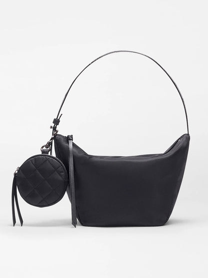 The MZ Wallace Small Waverly Hobo in Black Bedford features a single curved strap, a detachable small round quilted pouch, and REC Bedford fabrication, shown on a plain white background.