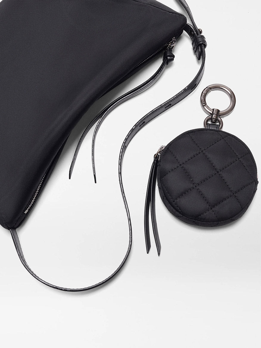 The MZ Wallace Small Waverly Hobo in Black Bedford features REC Bedford fabric, Italian leather trim, a long strap, and a round detachable pouch on a keyring, all shown on a white surface.