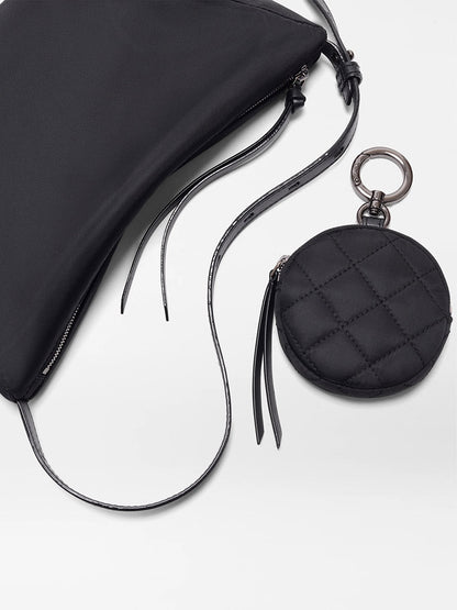 The MZ Wallace Small Waverly Hobo in Black Bedford features REC Bedford fabric, Italian leather trim, a long strap, and a round detachable pouch on a keyring, all shown on a white surface.