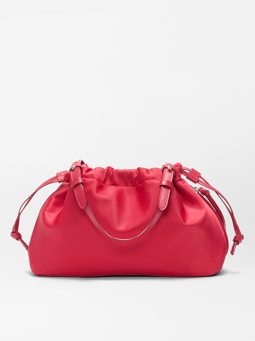 The MZ Wallace Small Waverly Shoulder in Apple Bedford is a bright pink satin bag with a gathered top, double adjustable straps, silver hardware, and a secure magnetic closure, shown against a plain light background.