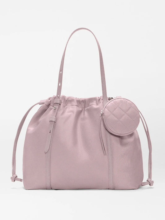 The MZ Wallace Small Waverly Tote in Quail Bedford features recycled nylon, Italian leather trim, adjustable shoulder straps, drawstring sides, and a small round zippered pouch on the front.