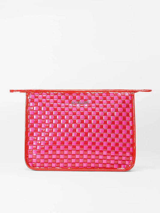 A MZ Wallace Woven Metro Clutch in Candy Lacquer with a pink and orange color palette on a white surface.