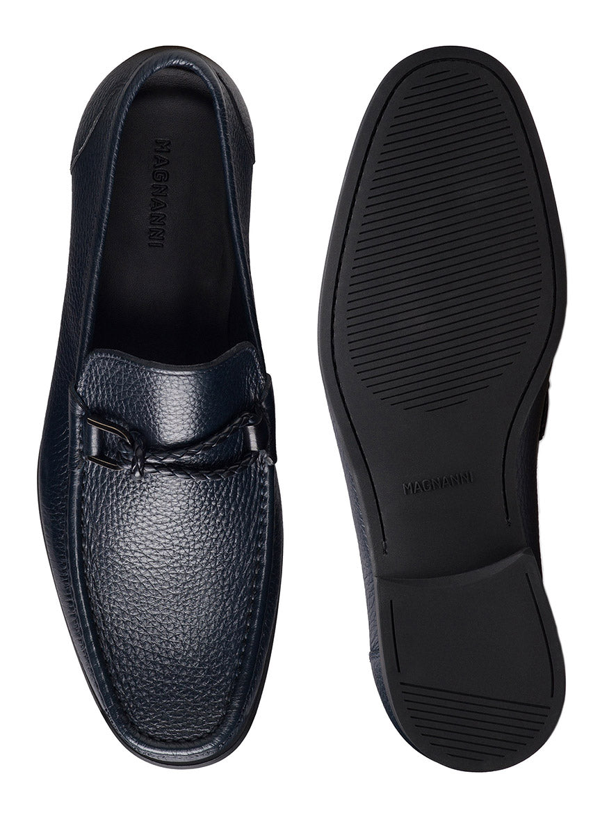 The Magnanni Gentry Soft Braid in Tumbled Navy loafers feature textured navy leather, a braided bit detail, moccasin construction, and rubber soles, shown from the top and bottom for a full view.