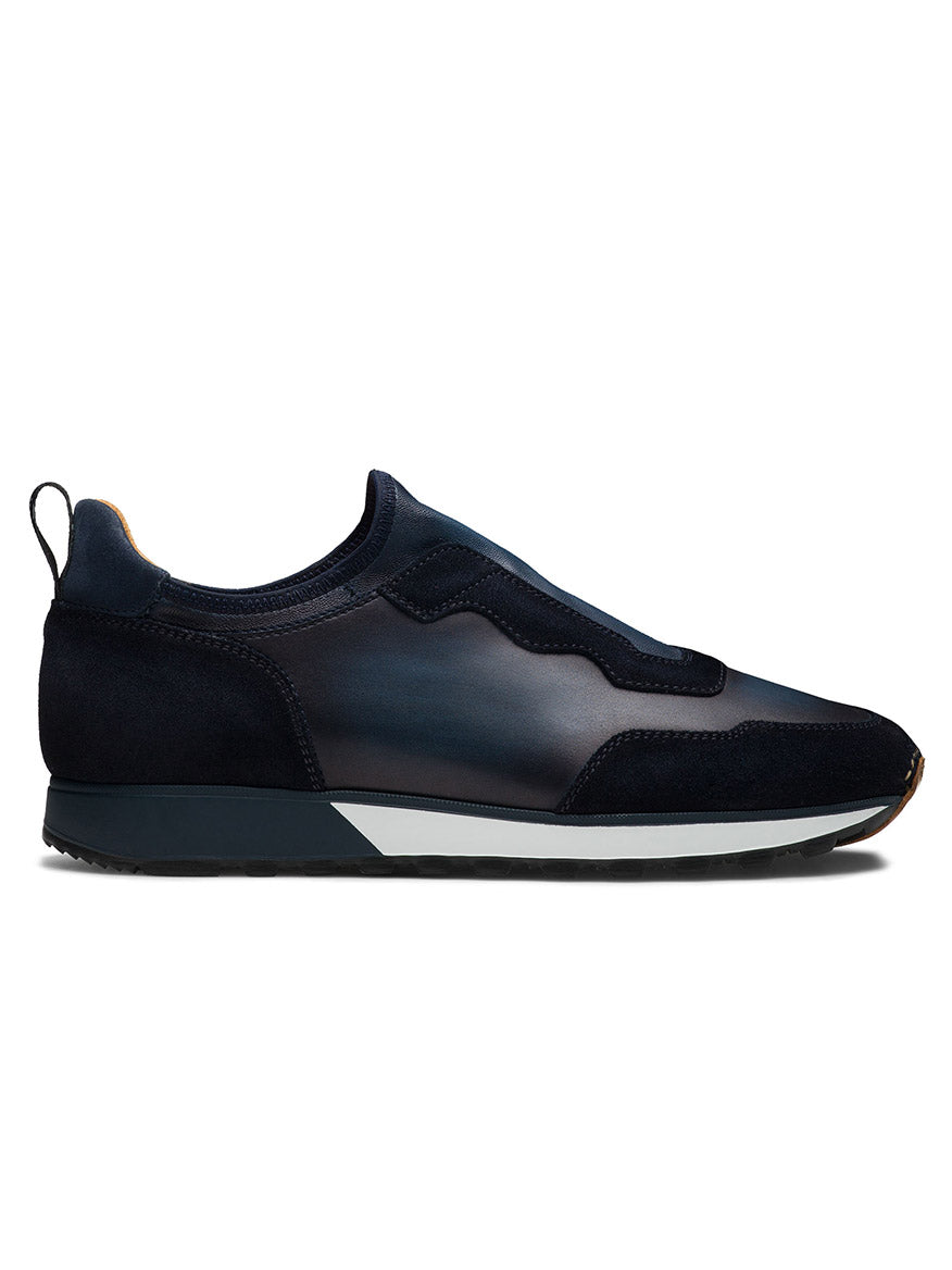 Side view of the Magnanni Arco Slip in Navy, a dark blue slip-on sneaker with a black sole and white midsole, showcasing a sleek, minimalistic design and retro-inspired sports sneaker charm accentuated by its stretch-napa gore system.