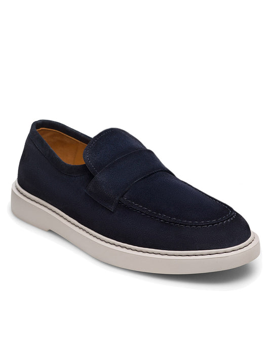 The Magnanni Bandera in Navy Suede is a timelessly elegant slip-on loafer, showcasing a visible stitch on the upper, a white sole, and viewed from the side.