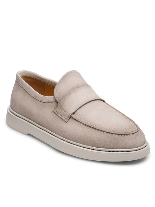 The Magnanni Bandera in Bone Suede is a slip-on loafer made from premium suede, featuring a minimalist design, subtle stitching, and a durable rubber sole for timeless elegance.