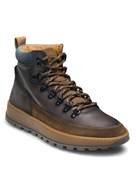 A taupe and grey high-top Magnanni Borazo hiker boot featuring black metal eyelets, tan laces, a cushioned brown sole, and a teal collar—perfect for rugged functionality during urban adventures.