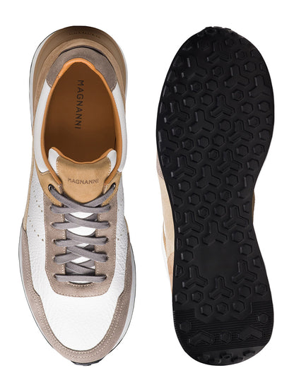The Magnanni Bravo V in Taupe Suede & White men's sneakers are shown from the top and sole, featuring taupe suede, white accents, and a black rubber outsole with a hexagonal tread pattern.