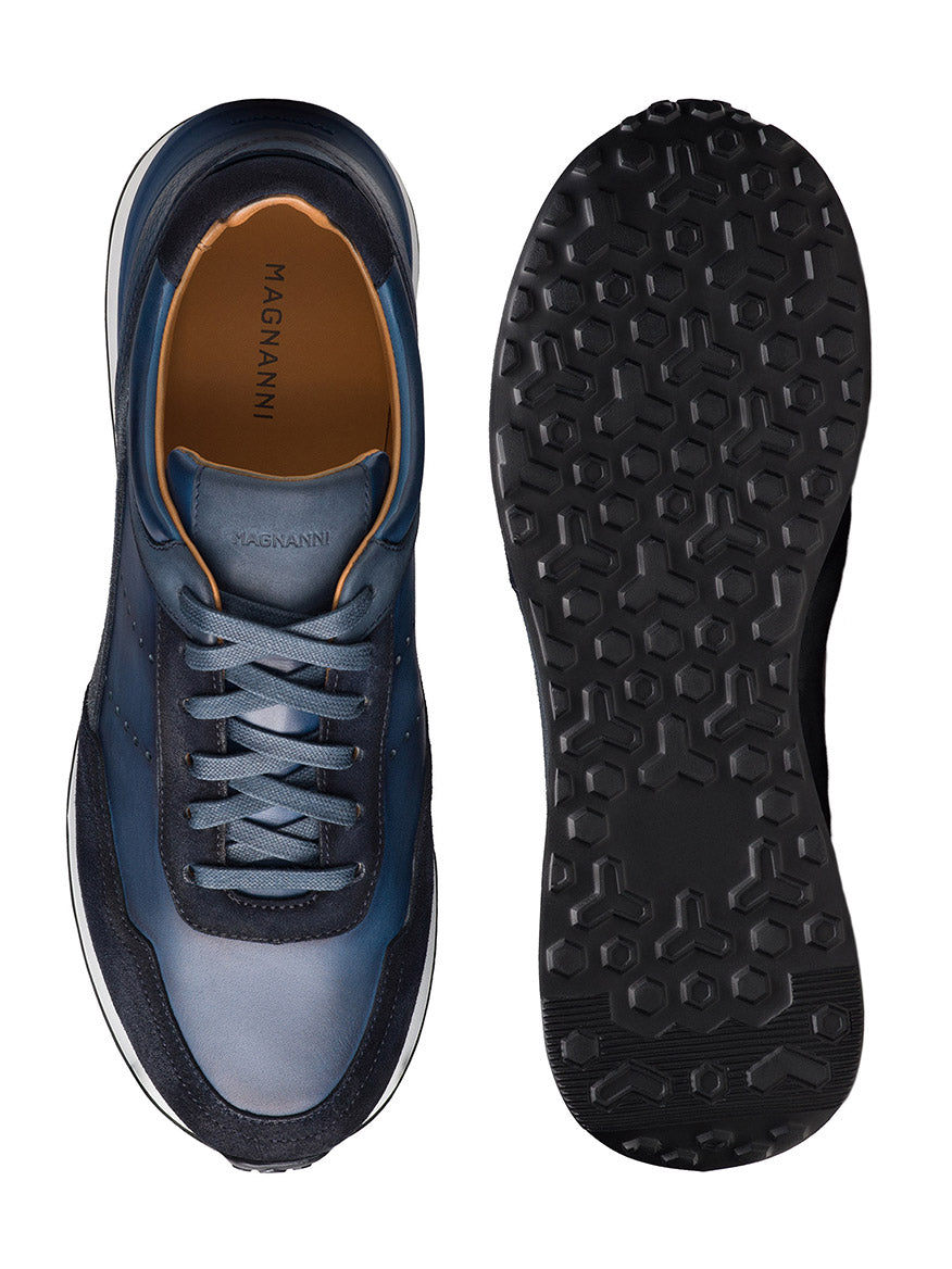 Top and bottom view of the Magnanni Bravo in Indigo/Navy; the top displays laces on blue leather, while the sport sole features a hexagonal tread pattern.