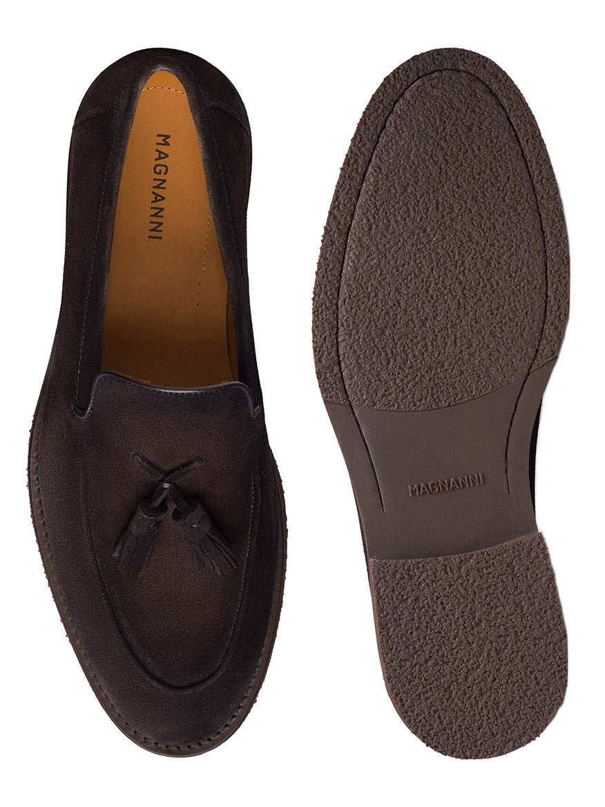 The Magnanni Cervan Tassel in Brown Suede, handmade in Portugal, is showcased from the top and bottom to highlight its elegant apron toe design and textured rubber sole. These luxury men’s tassel loafers exemplify refined craftsmanship and timeless style.