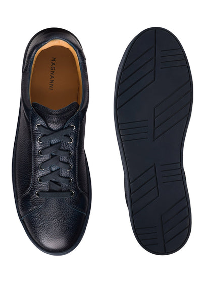 The Magnanni Cote Lo Stretch-Lace in Tumbled Navy men’s sneakers are shown from above and below, featuring a classic stretch lace-up top view and a textured rubber sole.