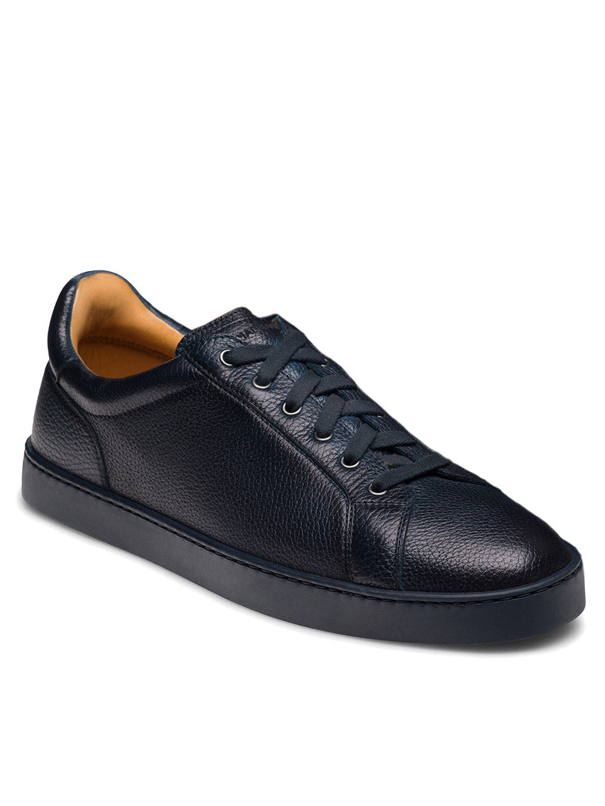 The Magnanni Cote Lo Stretch-Lace in Tumbled Navy is a men's low-top sneaker featuring navy textured leather, stretch-lace system, and a sleek navy rubber sole, shown against a white background.