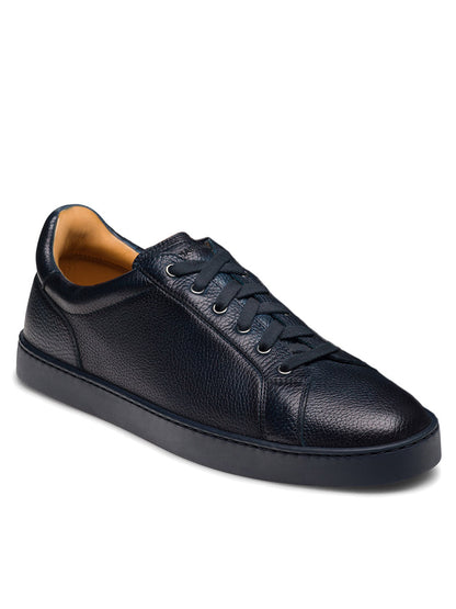 The Magnanni Cote Lo Stretch-Lace in Tumbled Navy is a men's low-top sneaker featuring navy textured leather, stretch-lace system, and a sleek navy rubber sole, shown against a white background.