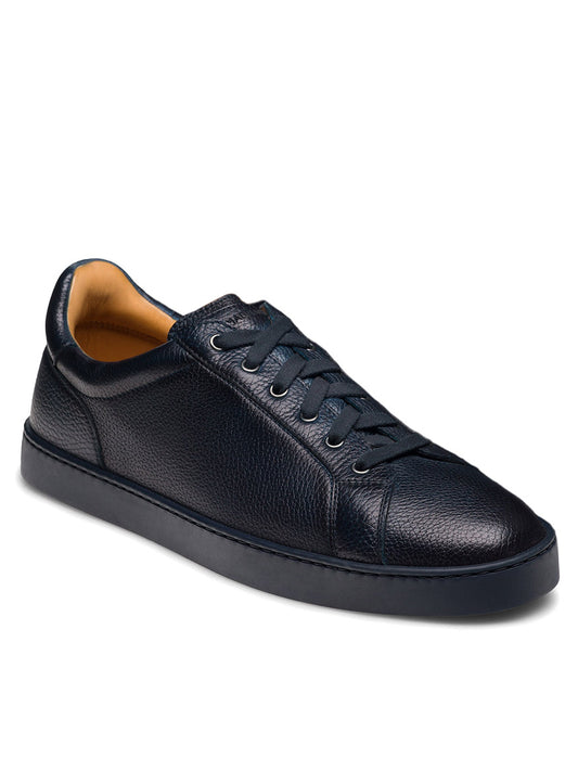 The Magnanni Cote Lo Stretch-Lace in Tumbled Navy is a men's low-top sneaker featuring navy textured leather, stretch-lace system, and a sleek navy rubber sole, shown against a white background.