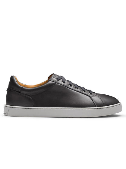 The Magnanni Cote Lo Stretch-Lace in Grey is a men’s low-top sneaker with a stretch-lace system, featuring grey leather and a white rubber sole, displayed in side profile against a plain background.