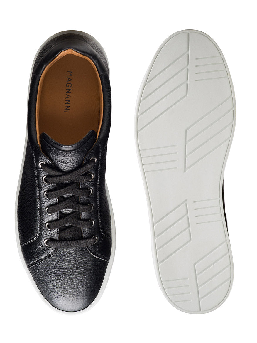 The Magnanni Cote Lo Stretch-Lace in Tumbled Black is a men's black leather low-top sneaker with a stretch-lace system and white rubber sole, shown from top and bottom views.