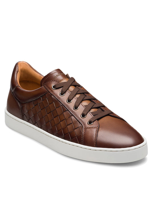 The Magnanni Cote Lo Woven Stretch-Lace in Tabaco is a brown woven leather sneaker with stretch brown laces and a white rubber sole, featuring intricate side detailing for a refined look. Shown on a white background.