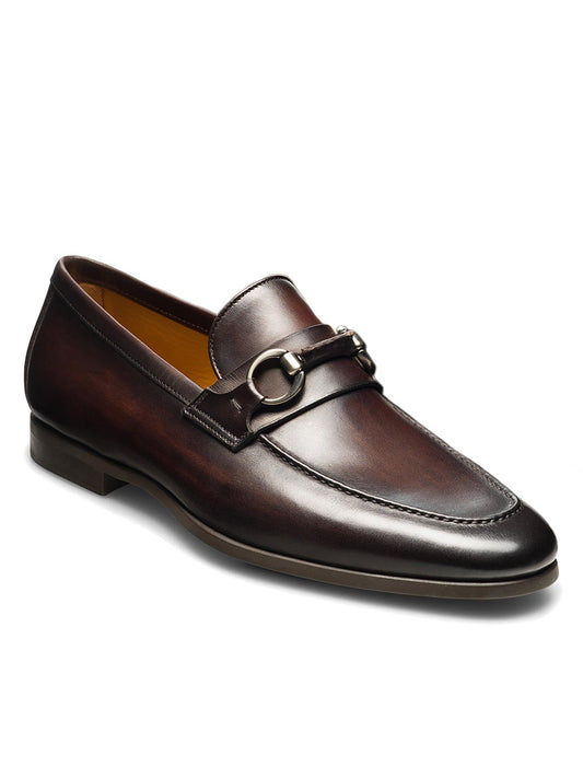 A single Magnanni Diago II in Brown with a moccasin toe design and metal bit detail on the vamp, featuring a cushioned rubber sole and a low heel, displayed against a white background.