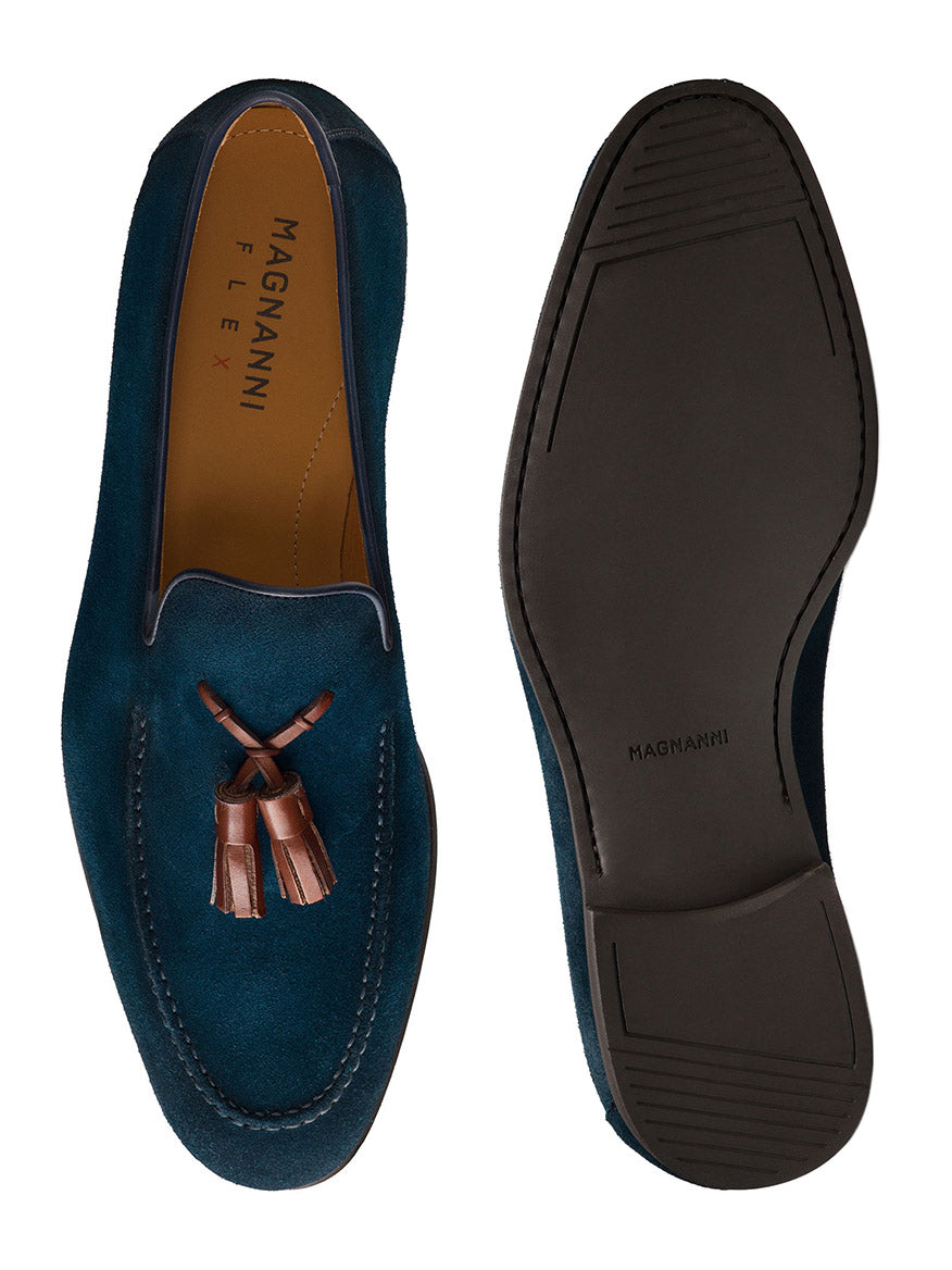 The Magnanni Dion in Navy Suede is shown from top and bottom views, featuring brown leather tassels and renowned Línea Flex construction. "Magnanni" labels on the insole and sole showcase its expert Spanish craftsmanship.
