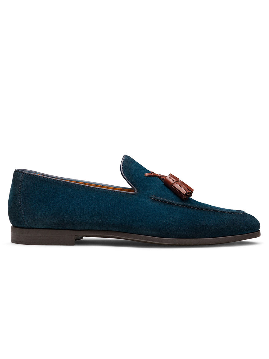 The Magnanni Dion in Navy Suede is a Spanish-made calfskin loafer with Línea Flex construction, a dark sole, and brown tassel detail, shown in side profile against a white background.