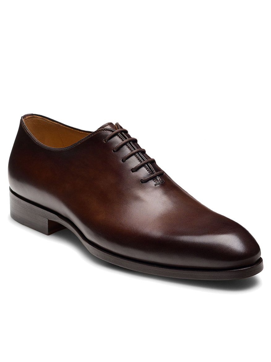 The Magnanni Fleur II in Tabaco is a luxury brown leather Oxford dress shoe featuring closed lacing and a low heel, shown on a white background.