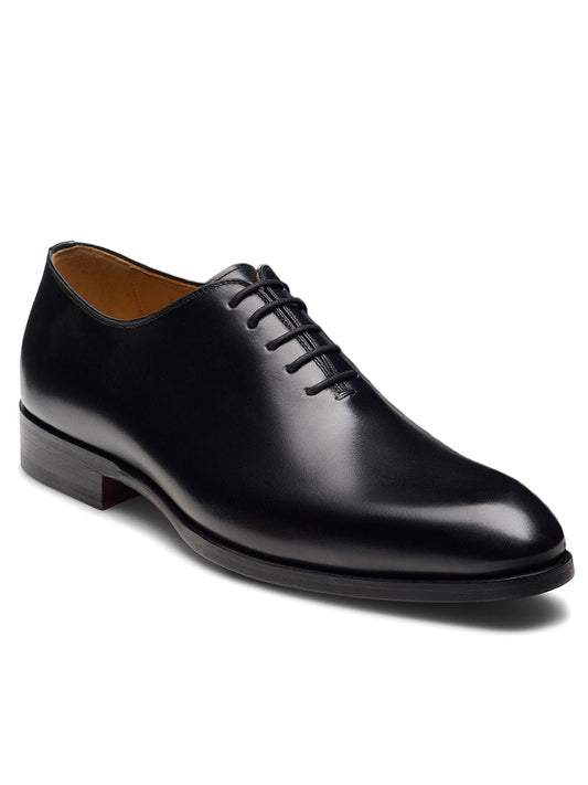 The Magnanni Fleur II in Black is a luxury Oxford dress shoe crafted from black leather, featuring closed lacing, a smooth finish, and a low wooden heel, shown from a slight angle.