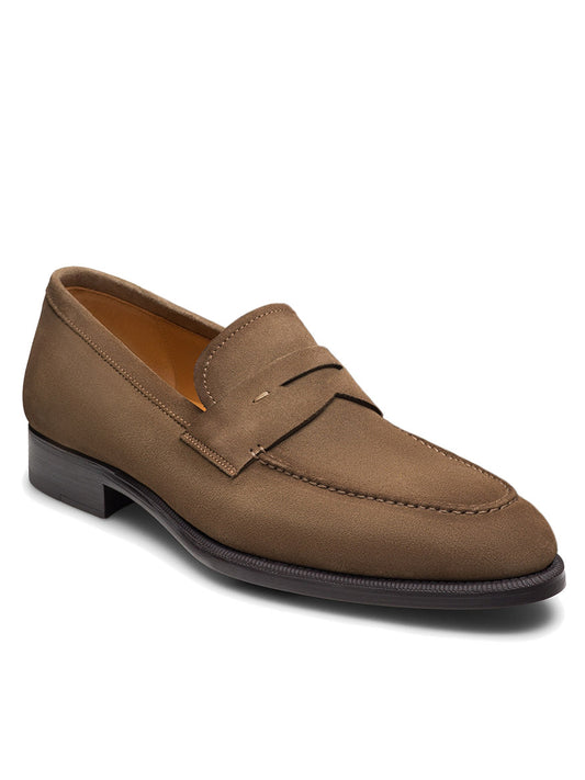 The Magnanni Garner in Taupe Suede, a penny loafer with visible stitching, low heel, and leather sole, is displayed at an angle on a white background—an ideal smart-casual shoe.