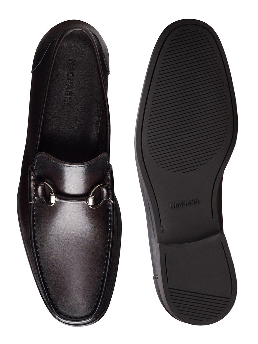 The Magnanni Gentry Soft Bit in Brown is a men's leather loafer with a metal bit detail, shown from the top and bottom to highlight its dark brown upper design and durable rubber sole.