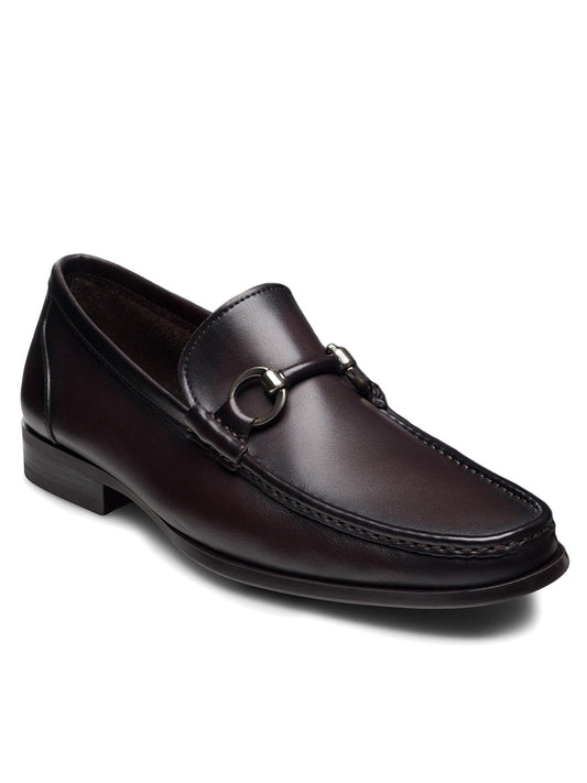 The Magnanni Gentry Soft Bit in Brown is a dark brown loafer with a metal bit detail on the upper and a low heel, displayed at an angled view on a white background.
