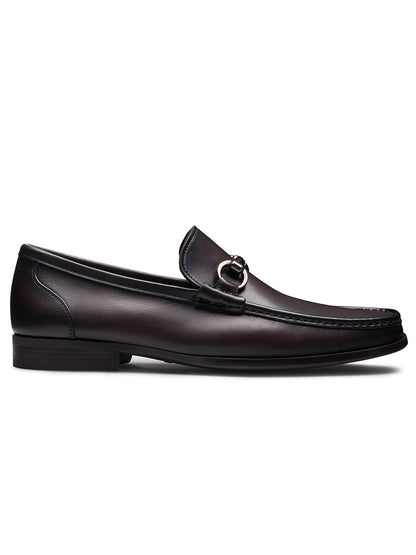 The Magnanni Gentry Soft Bit in Brown is a dark brown handcrafted moccasin leather loafer featuring a low heel and metal bit detail, displayed in a side profile view.
