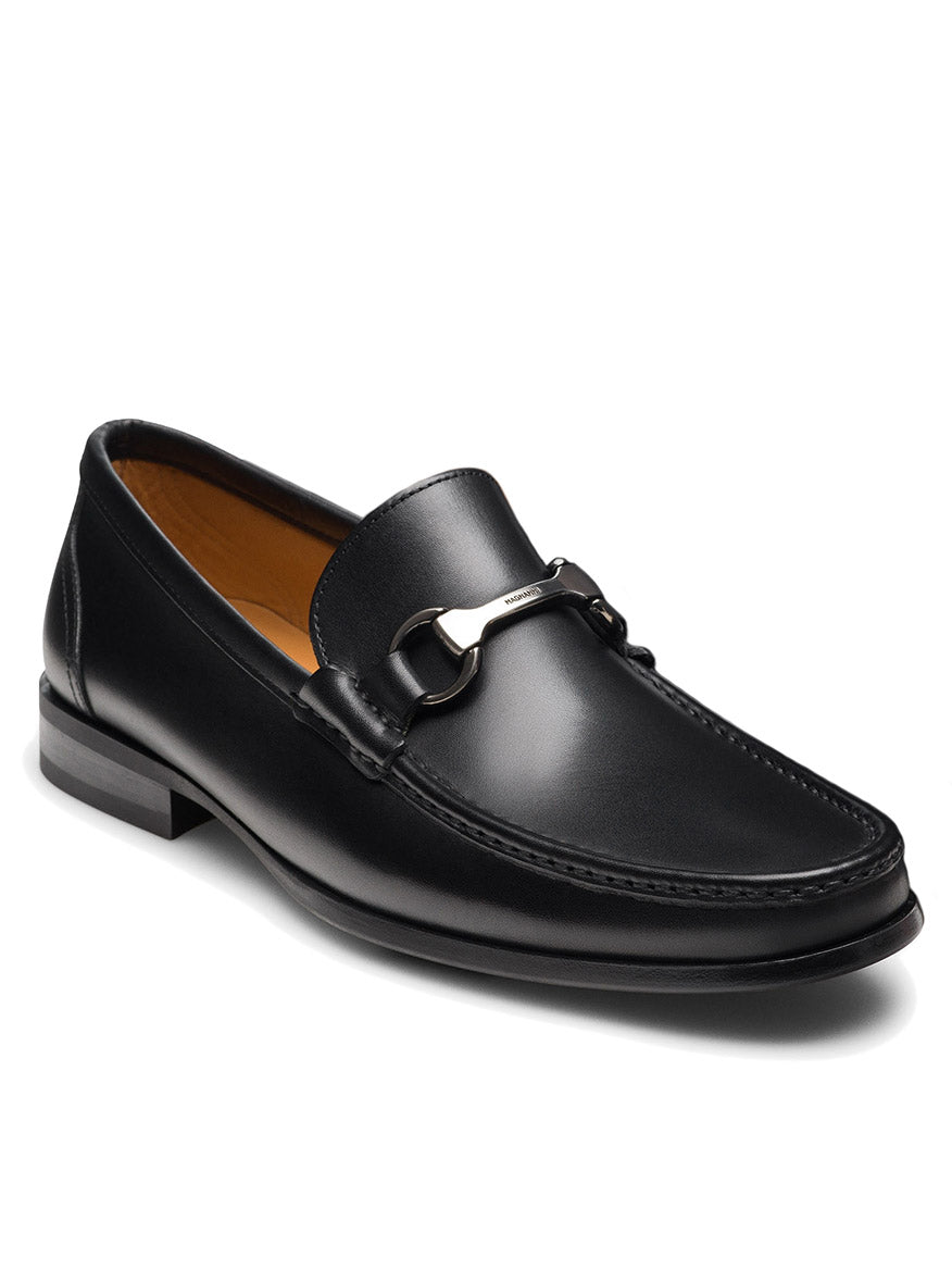 The Magnanni Gentry in Black is a black leather bit loafer featuring a silver metal detail, low heel, brown lining, and classic moccasin-inspired stitching.
