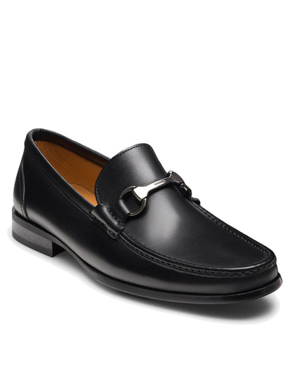 The Magnanni Gentry in Black is a black leather bit loafer featuring a silver metal detail, low heel, brown lining, and classic moccasin-inspired stitching.