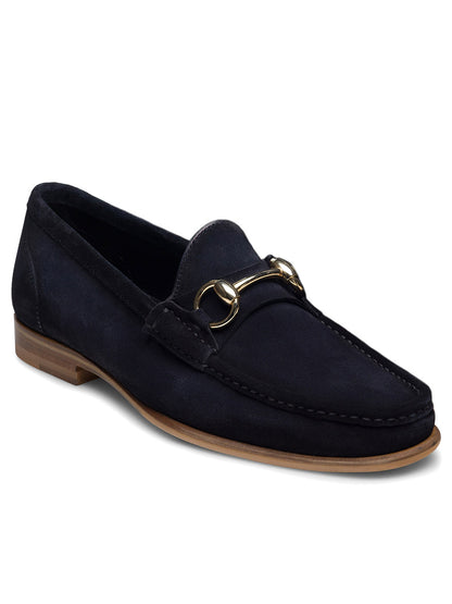 The Magnanni Giancarlo in Navy Suede is a hand-stitched moccasin loafer featuring dark navy suede, a gold horsebit detail on the front, and a light brown sole.