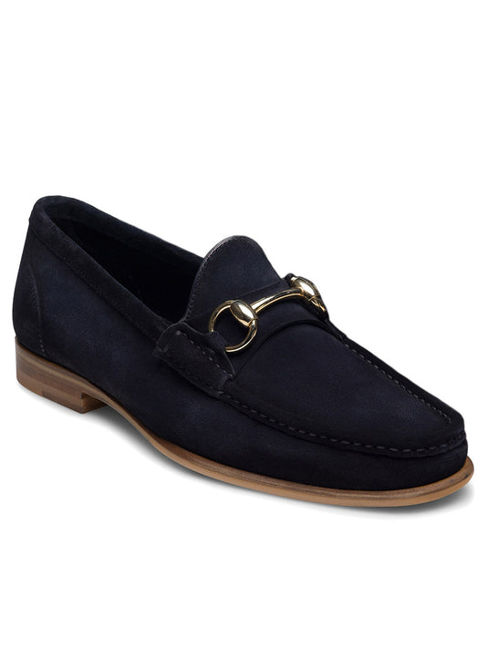 The Magnanni Giancarlo in Navy Suede is a hand-stitched moccasin loafer featuring dark navy suede, a gold horsebit detail on the front, and a light brown sole.