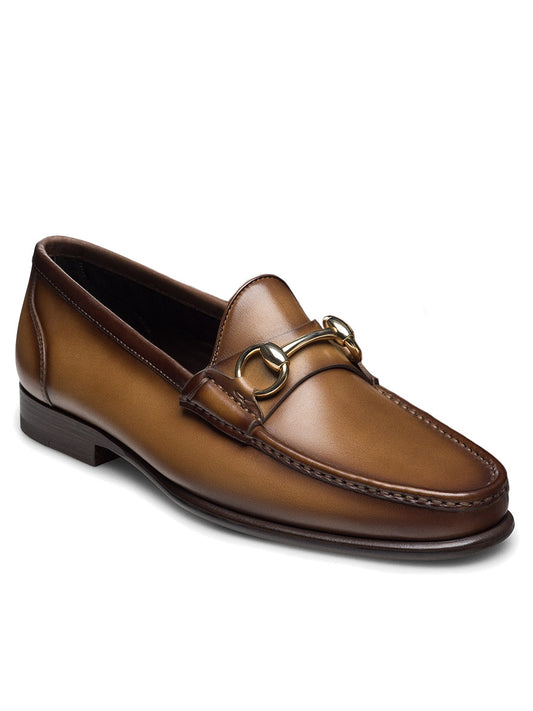 The Magnanni Giancarlo in Brown is a leather moccasin loafer with a polished bit ornament, low heel, and stitched toe.