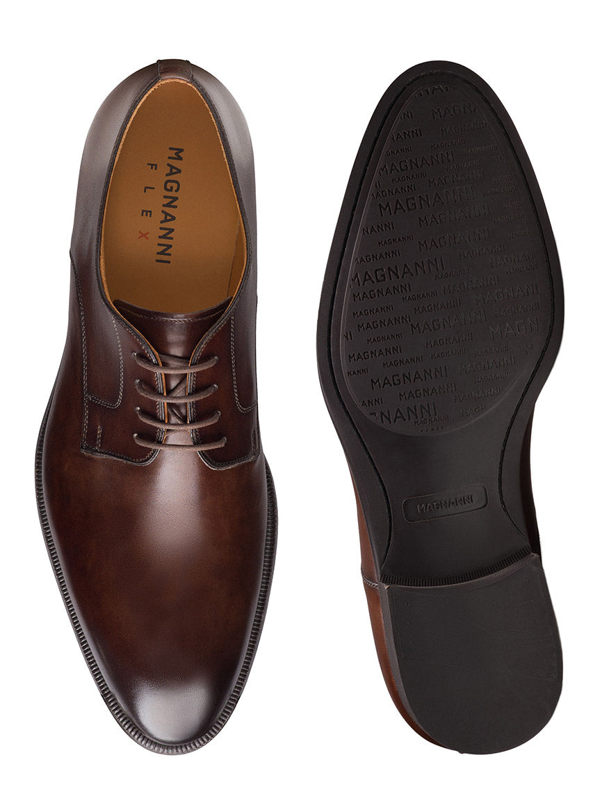 The Magnanni Haans in Brown are men's plain toe derby dress shoes with leather uppers, lace-up closure, and visible branding on the insole and sole—ideal for completing your business look. Shown from top and bottom views.