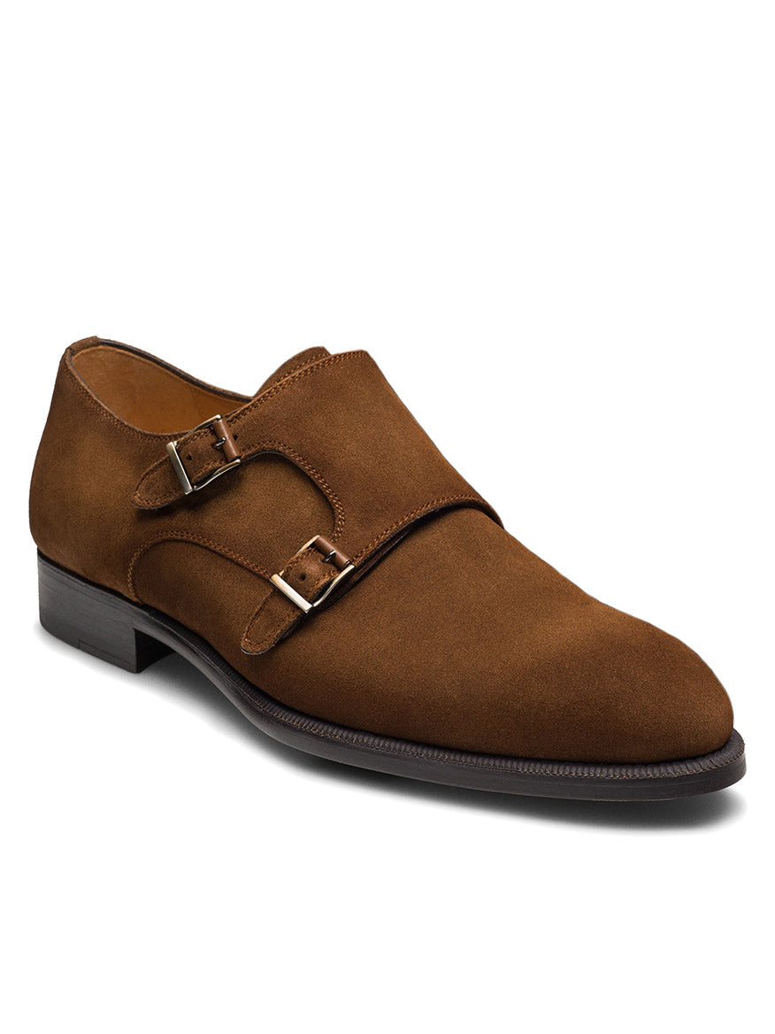 The Magnanni Harmon in Cognac Suede is a double monk strap dress shoe with two silver buckles, cushioned footbed, low heel, and black sole—ideal for stylish office wear. Shown against a white background.