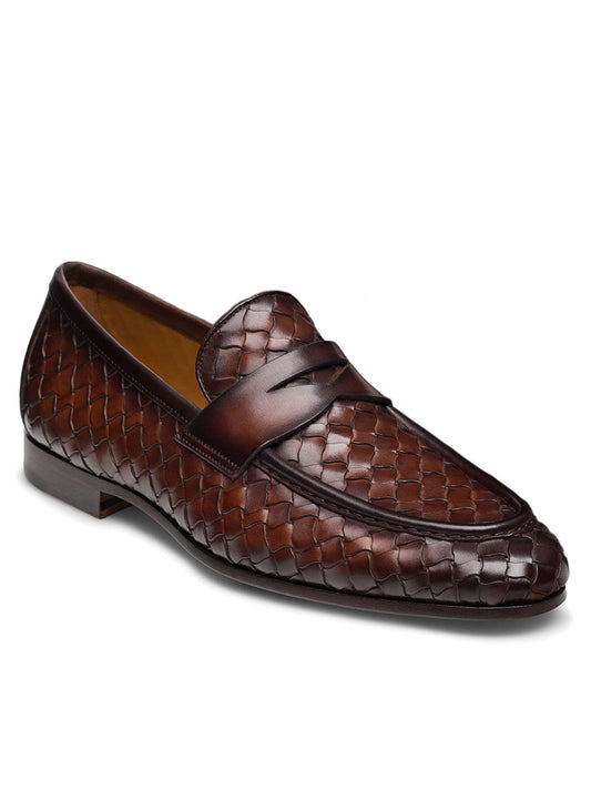 The Magnanni Hyde in Midbrown loafer showcases an elegant, hand-woven leather design with a low heel and Bologna construction for enhanced comfort.