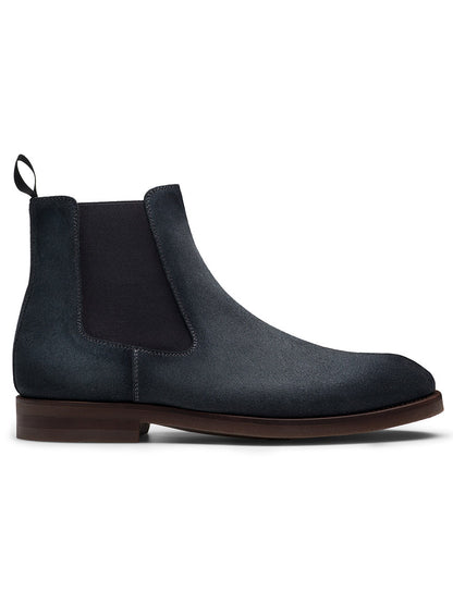 The Magnanni Java in Indigo Suede is a single dark blue Chelsea boot, featuring elastic side panels, a pull tab at the back, and a cushioned rubber sole for extra comfort, viewed from the side.