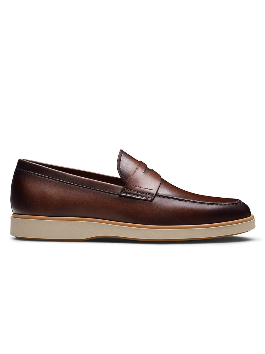 The Magnanni Lalo II in Brown is a men’s penny loafer with a classic strap and light beige rubber sole, shown in a side profile on a white background.