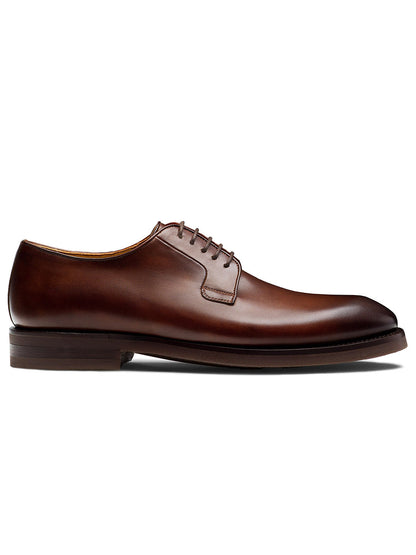 The Magnanni Lanai in Midbrown, a leather dress shoe with a lace-up closure and a low heel, showcases Bologna construction for enhanced flexibility and comfort, as seen from the side.