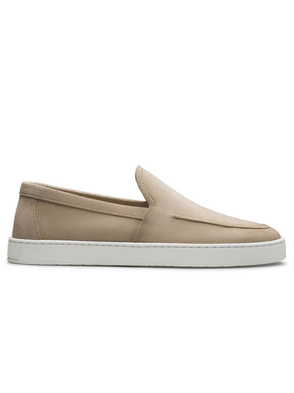The Magnanni Lawford Venetian Flex in Tierra Suede is a beige slip-on sneaker with a white rubber sole, minimalist design, and smooth suede upper—shown in side profile, crafted for signature Magnanni comfort and style.