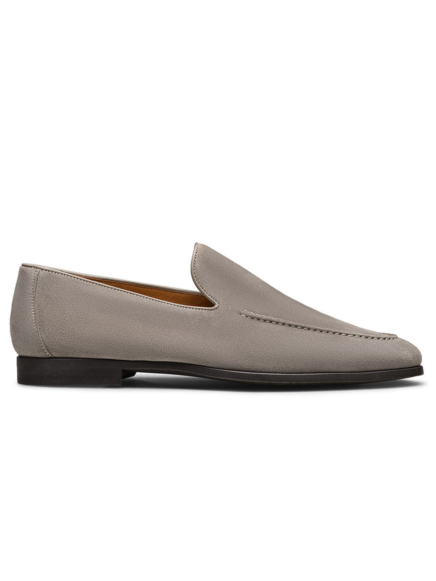 The Magnanni Lecera II in Tierra Suede is a gray suede Venetian loafer featuring a leather upper, minimal stitching, and a low black heel, displayed in profile against a white background.