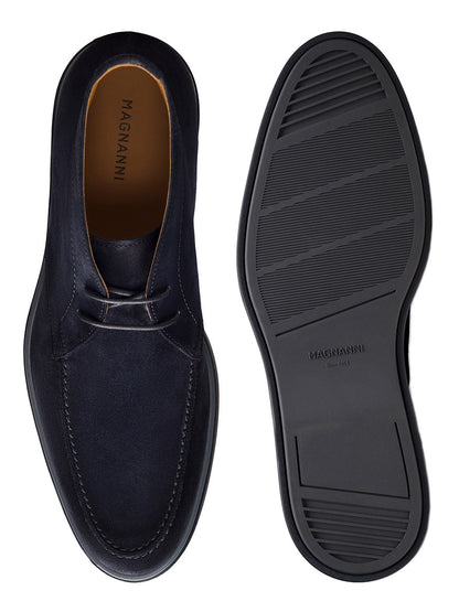 Top and bottom views of a navy suede Magnanni Lello dress shoe, handmade in Portugal, with a stitched upper and a rubber sole featuring grooves for grip.
