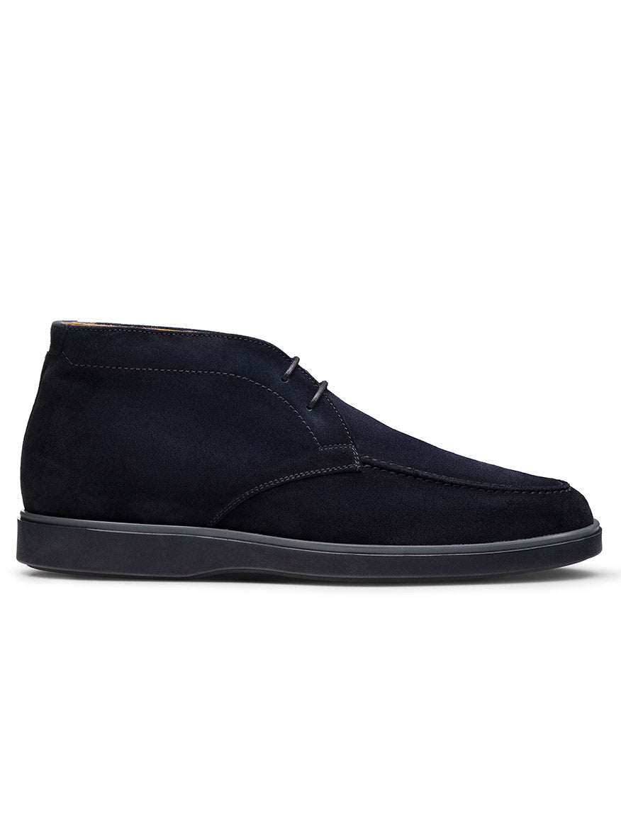 Magnanni Lello in Navy Suede—a navy suede chukka boot with two eyelets, visible stitching, and a black rubber sole, handmade in Portugal for comfort, shown from the side against a white background.