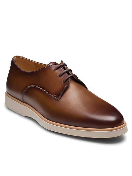 Magnanni Leone II in Tabaco: brown leather hybrid dress shoe with a white sole, closed lace-up design, and minimal stitching detail, shown on a white background.